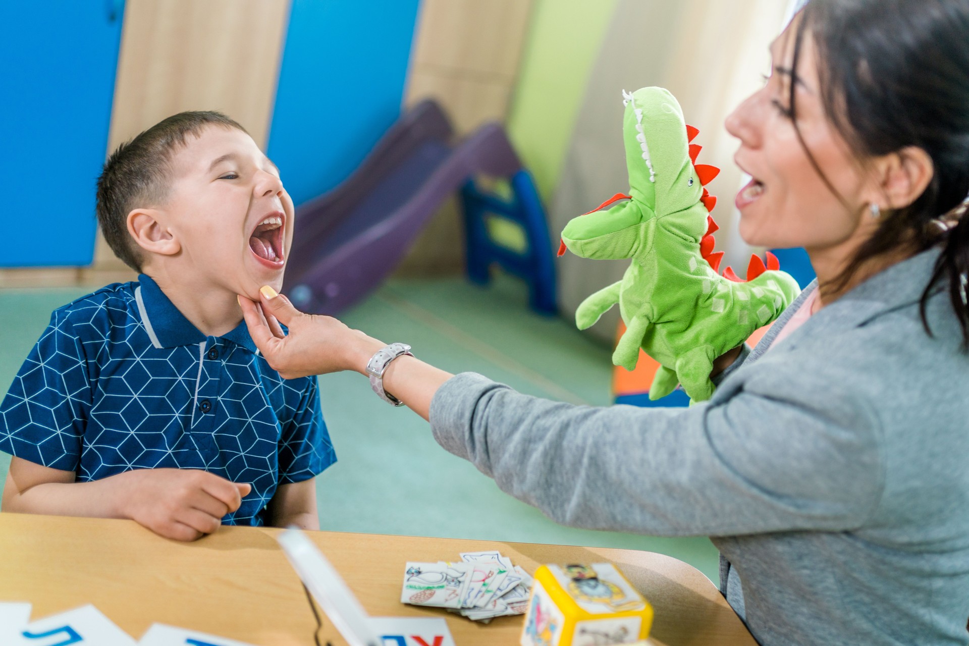 Woman Therapist and Boy During Lesson to Correcting Pronunciation