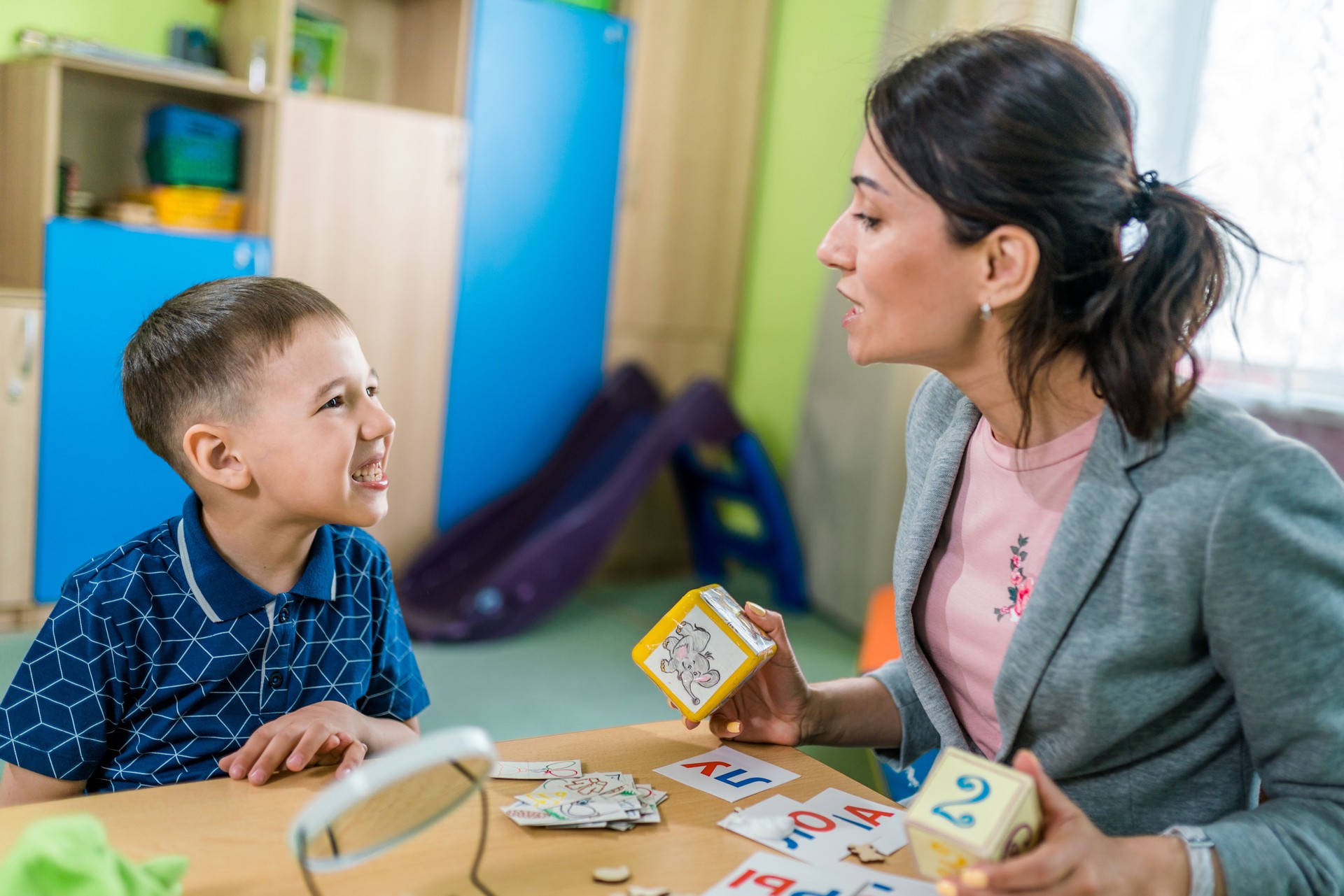 Woman Speech Therapist and Boy During Lesson to Correctly Articulation